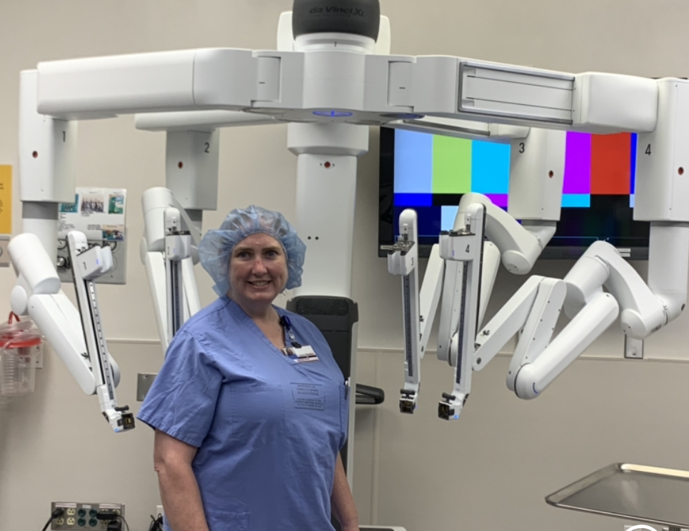 Dr. Shelton standing in front of the daVinci surgical robotic equipment.